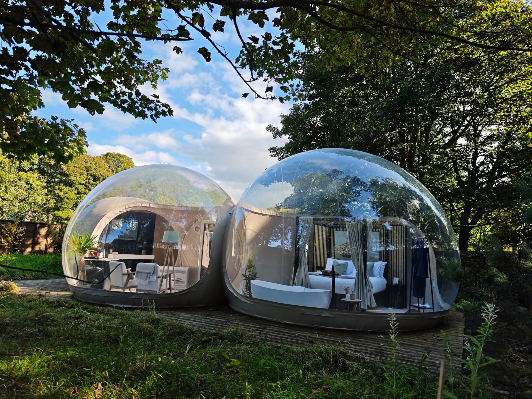 Two luxury bubble domes at Cromore Retreat set on decking among woodland